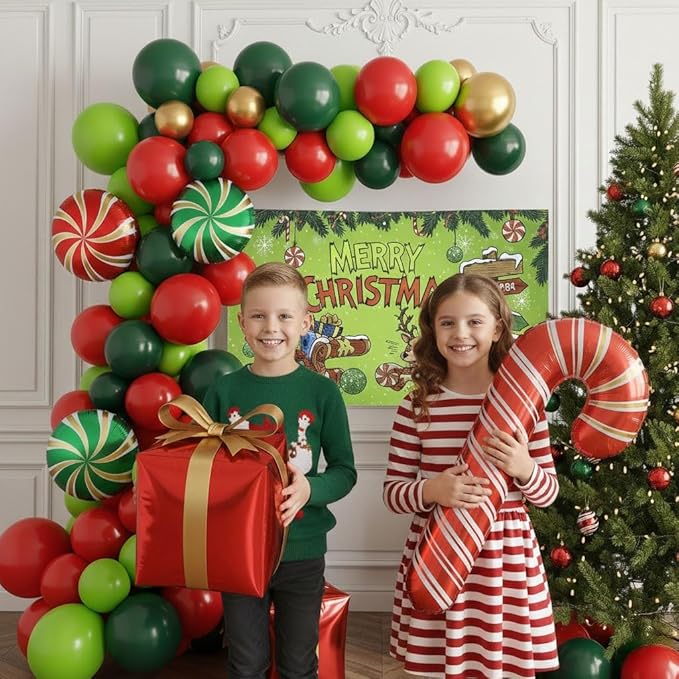 Christmas cartoon style party decorations include green red and gold balloon arch kit & candy canes lollipops gift boxes foil balloons & backdrop for Christmas New Year's Eve party decorations.